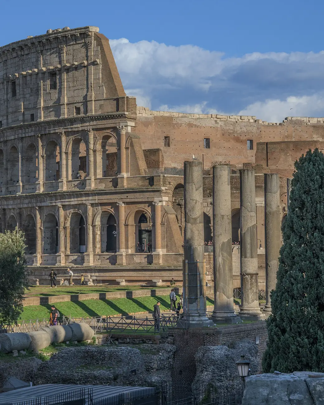 Coliseu de Roma com colunas do Foro Romano em primeiro plano
