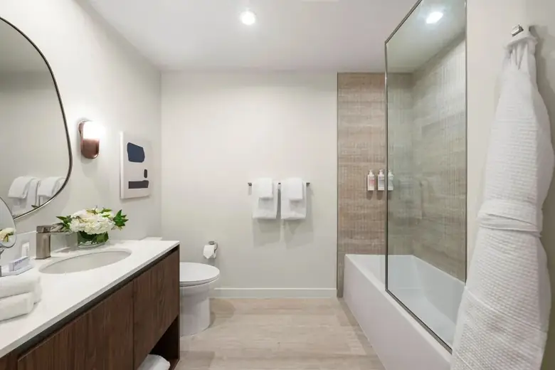 Banheiro de um flat do Domus Brickell Park, com banheira e toalhas Frette