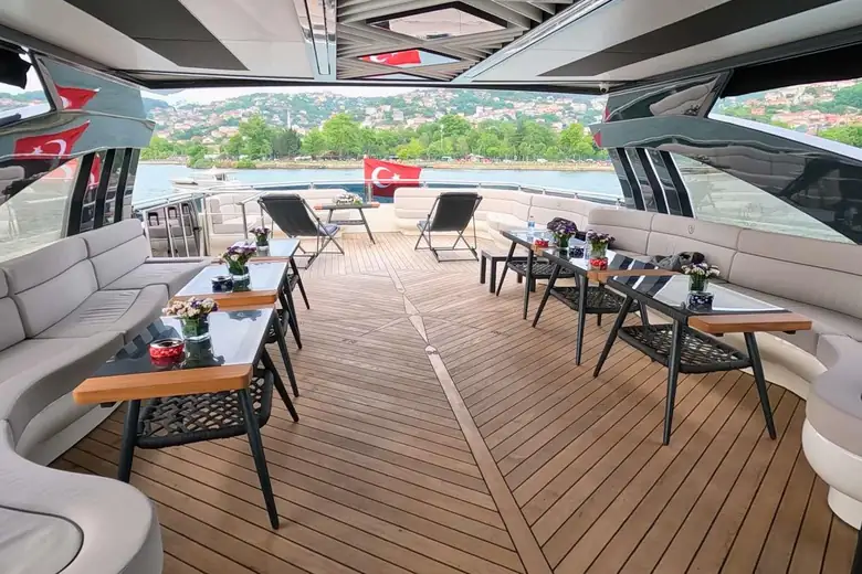 Deck de popa em teca com lounges, mesas e flores